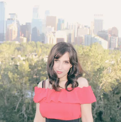 A black and white photo of Victoria Genest, a singer and artist.